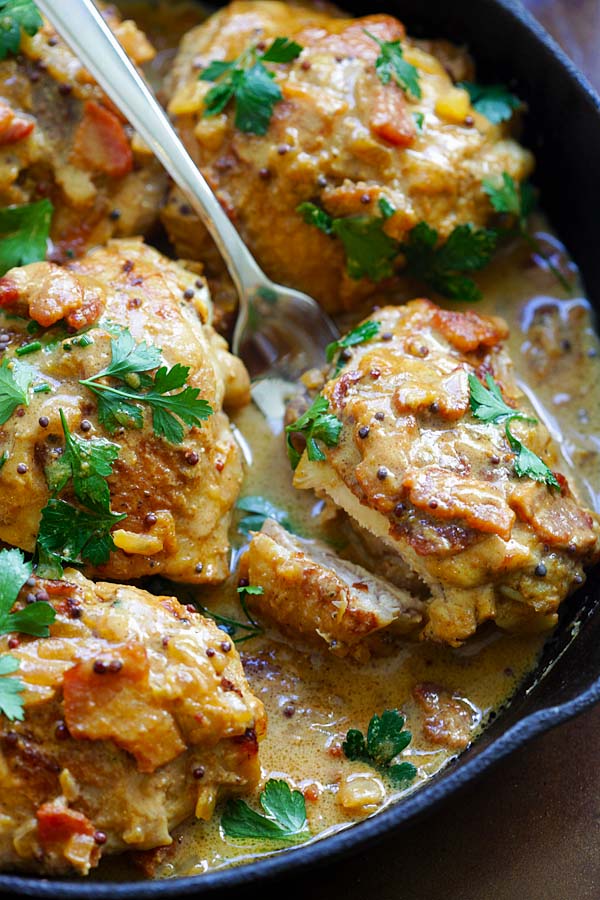 Creamy mustard chicken in a skillet with a fork.