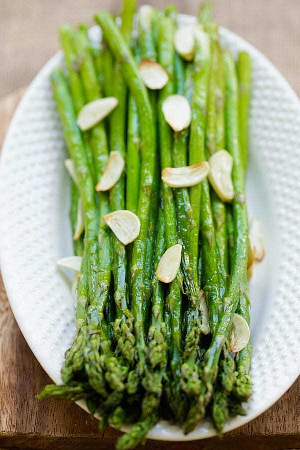 Homemade oven baked asparagus with garlic in a serving dish.