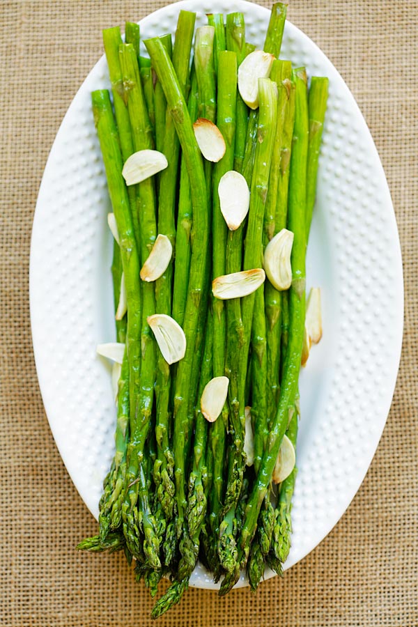 Top down view of healthy roasted asparagus with garlic.