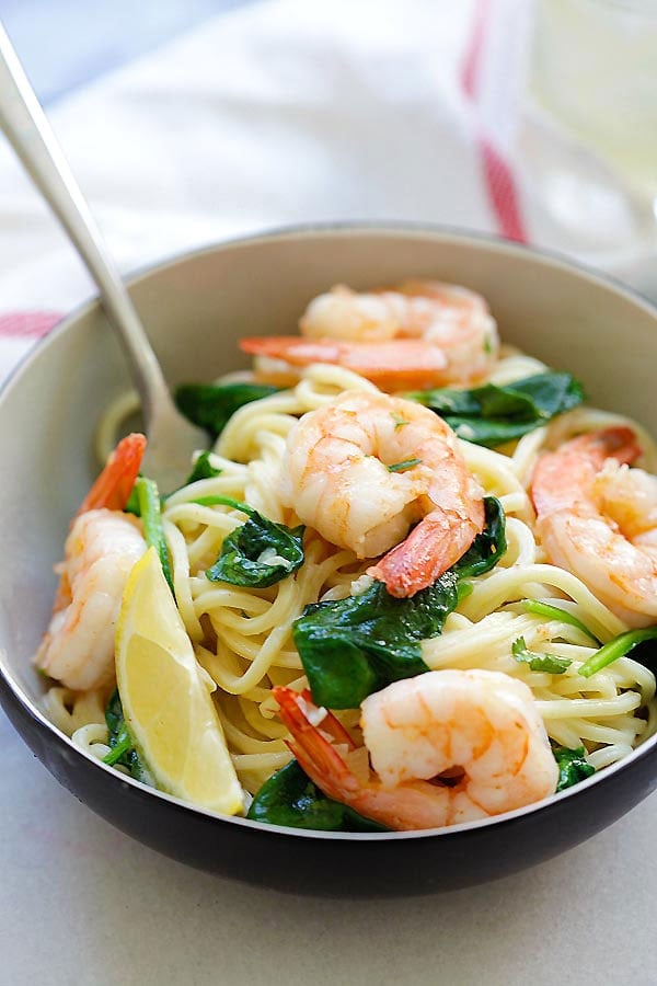 Healthy easy shrimp and spinach spaghetti twirled with a fork.