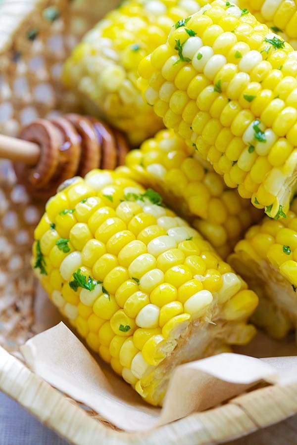 Close up sweet corns coated in buttery honey butter.