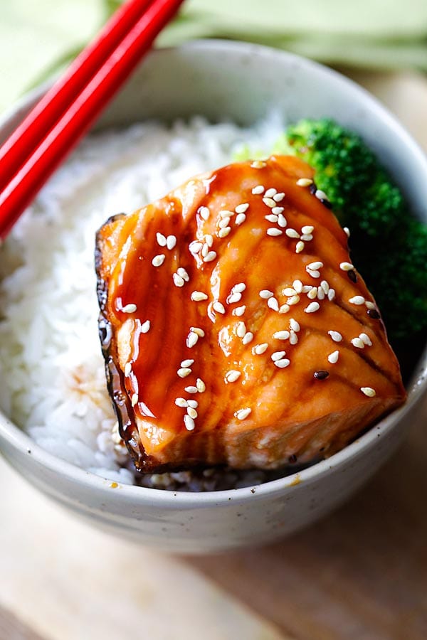 Salmon teriyaki in a Japanese bowl and served with a pair of chopsticks.