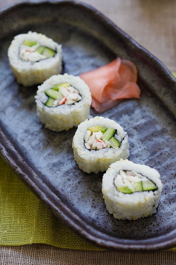 California roll on a plate with picked ginger.