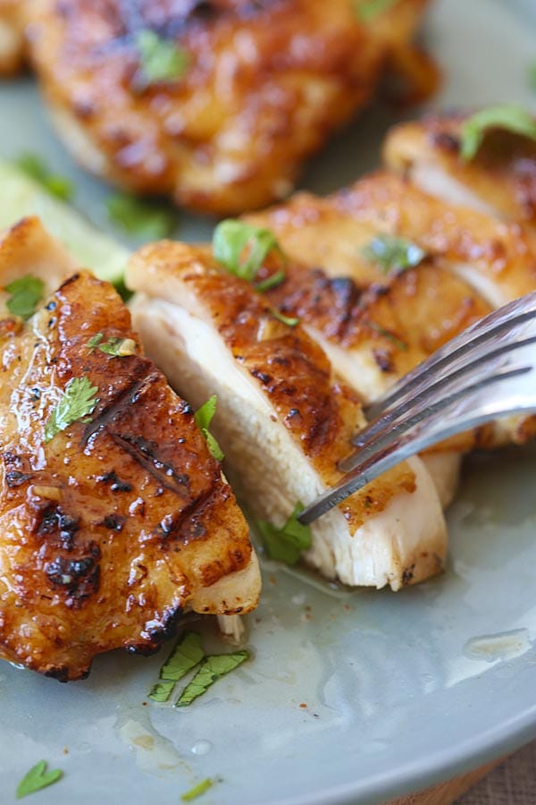 A piece of tequila lime chicken poked with a fork.