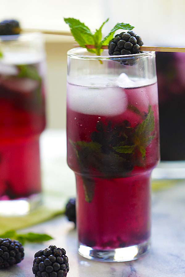 classic blackberry mojito with mint leaves and fresh blackberries, serve in a glass with ice.