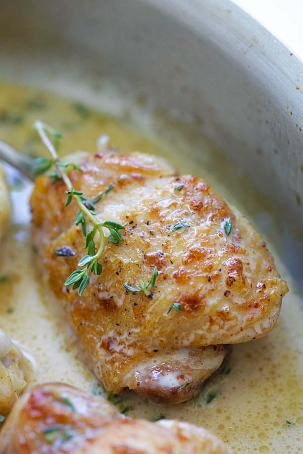 Healthy homemade one-skillet creamy garlic chicken topped with thyme.