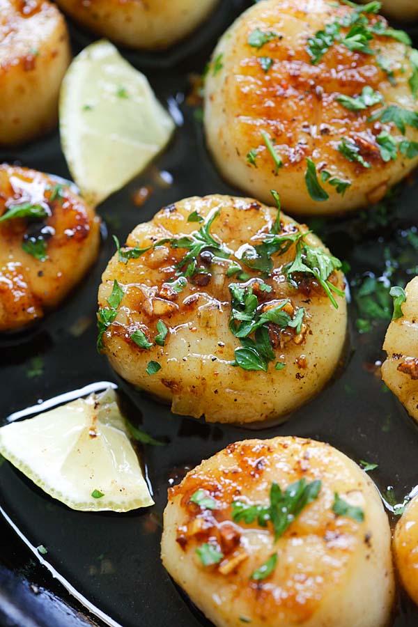 Close up seared scallops with brown butter and honey garlic glaze.