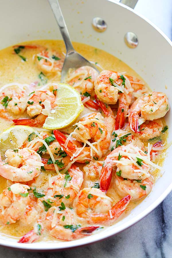 Homemade delicious lemon shrimp with rich, buttery, creamy garlic Parmesan sauce in a skillet.