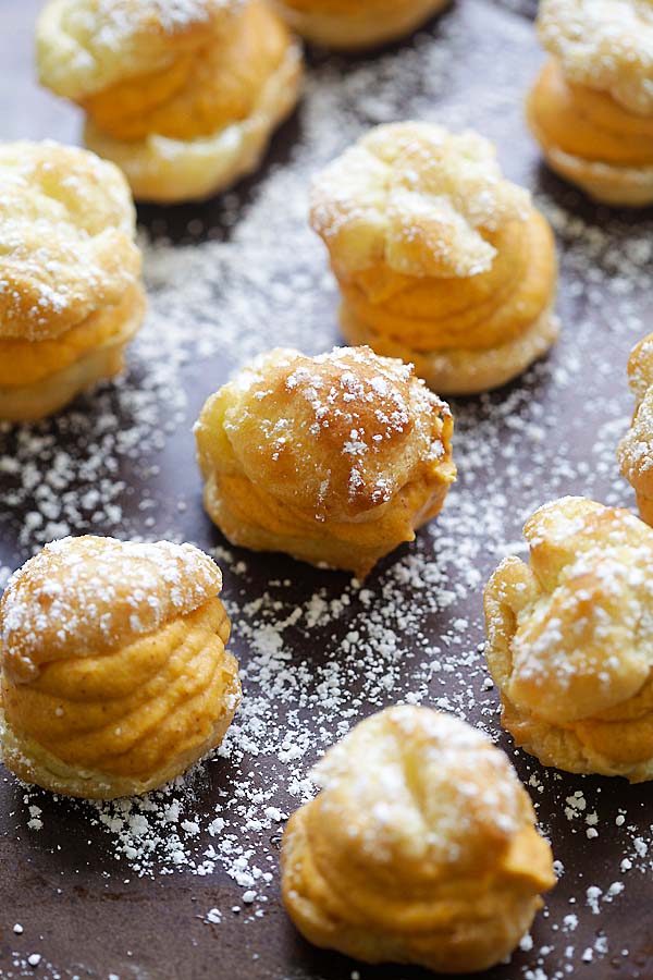 Festive puffy choux pastry filled with sweet pumpkin cream filling.