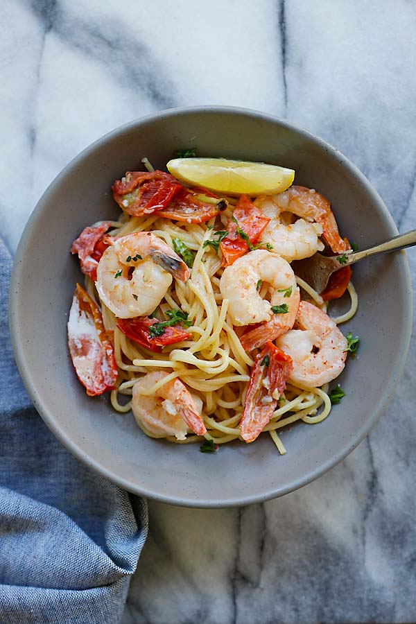 Creamy one-pot pasta with shrimp and sun-dried tomatoes in a plate ready to serve.