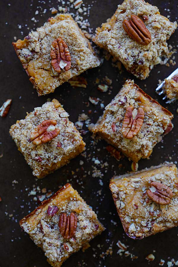 Top down view of pumpkin pecan cheesecake bars in cube sizes, ready to serve.