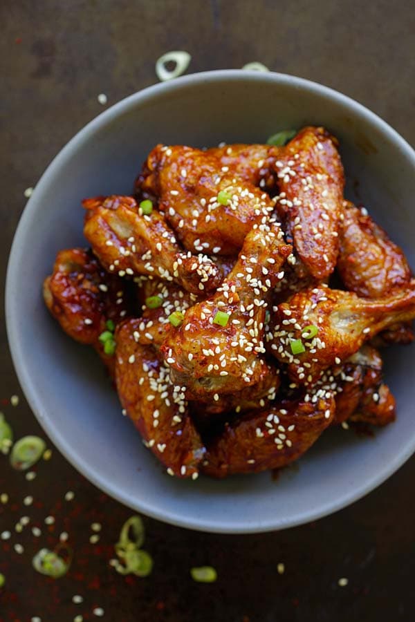 Baked Korean chicken wings with sweet and spicy gochujang glaze in a bowl.