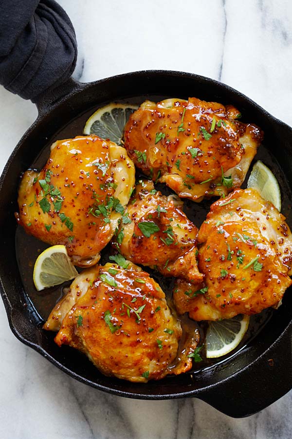 Spicy honey-glazed chicken cooked in a skillet.