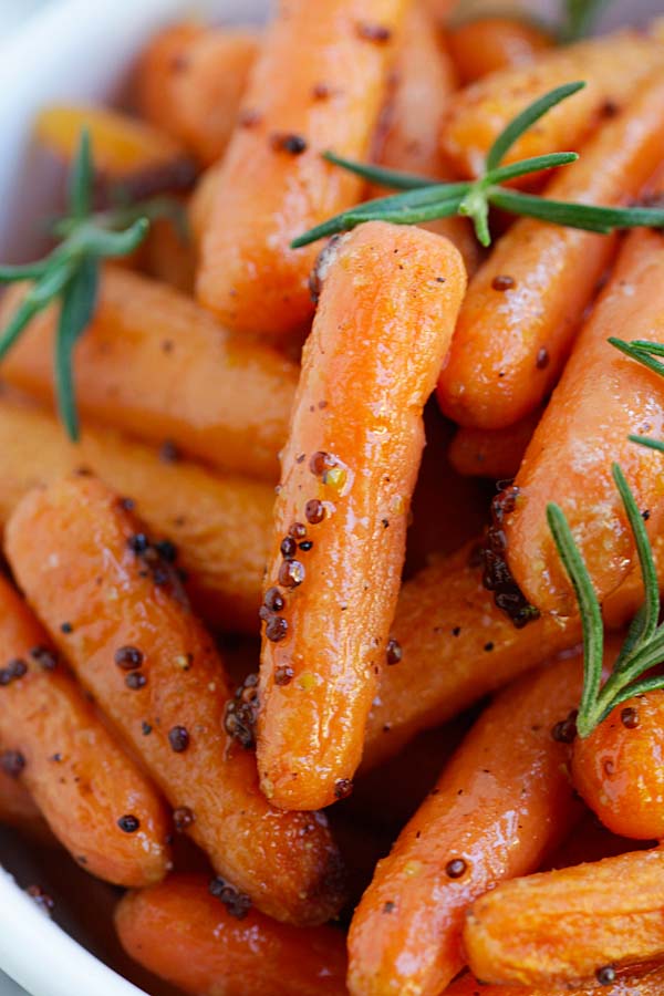 Close up easy and quick maple and dijon mustard roasted baby carrots.