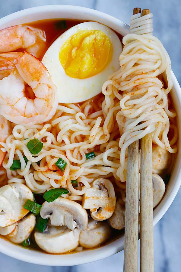 Closed up of easy homemade ramen with spicy Sriracha broth in a bowl.