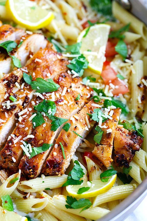 Easy and delicious creamy pasta with spicy blackened spice chicken breast garnished with shredded cheese.