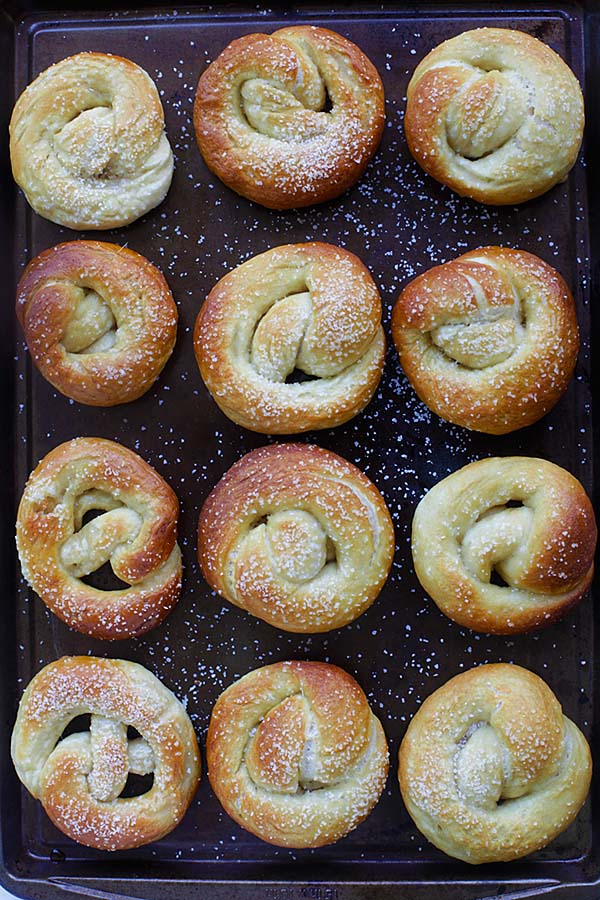 Pretzels on a baking tray salted and buttered.