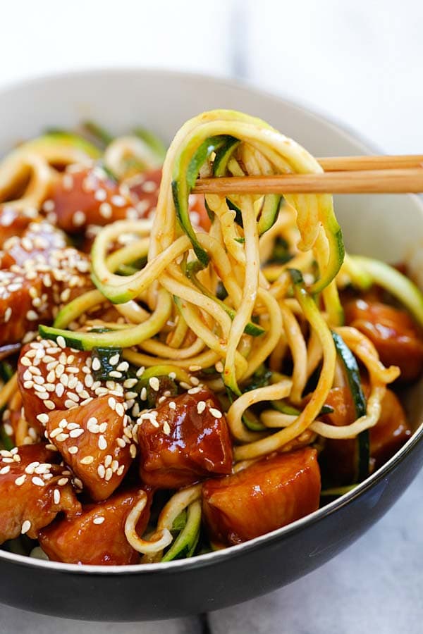 Easy and delicious homemade honey sriracha chicken zucchini noodles ready to serve.