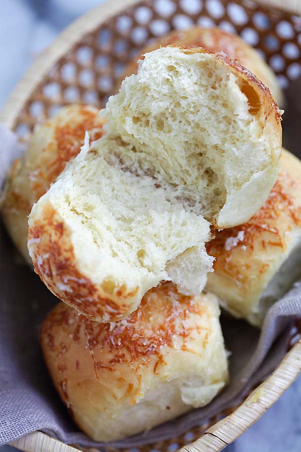 Easy homemade cheesy Parker House rolls in half, ready to serve.