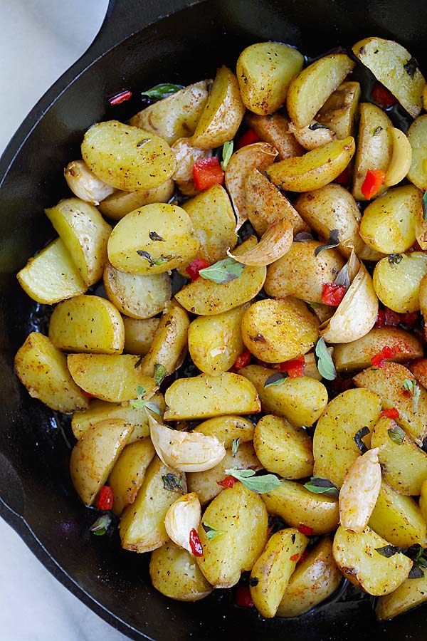 Top down view of Greek oven-roasted potatoes in a skillet.