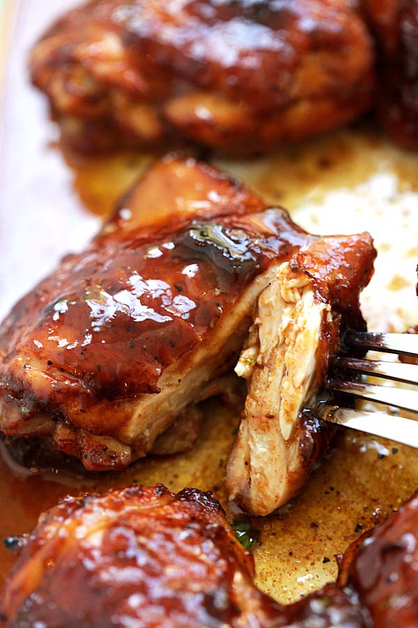 Homemade oven-baked chicken thighs marinated with brown honey barbecue sauce, ready to serve.