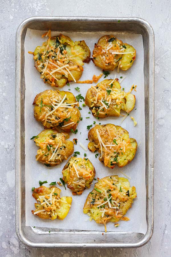 Easy and quick Garlic Parmesan Smashed Potatoes in a baking tray.