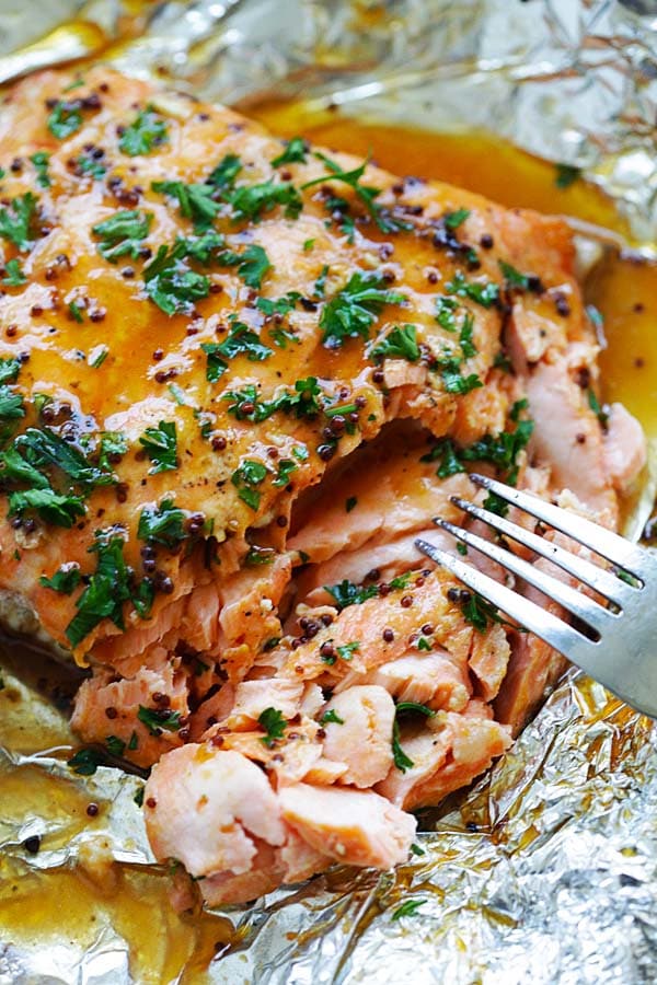 Flaky and juicy spicy honey salmon with a fork.