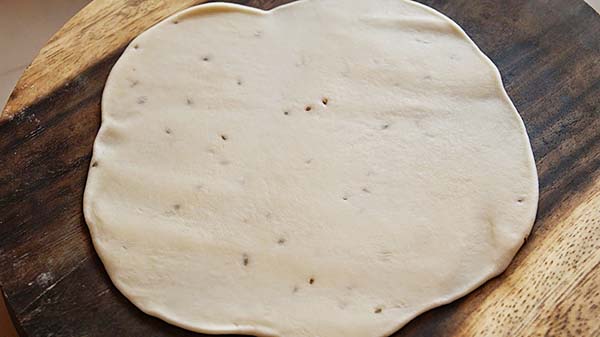 Homemade samosa dough and samosa wrapper on a flat surface, ready to wrap samosas.