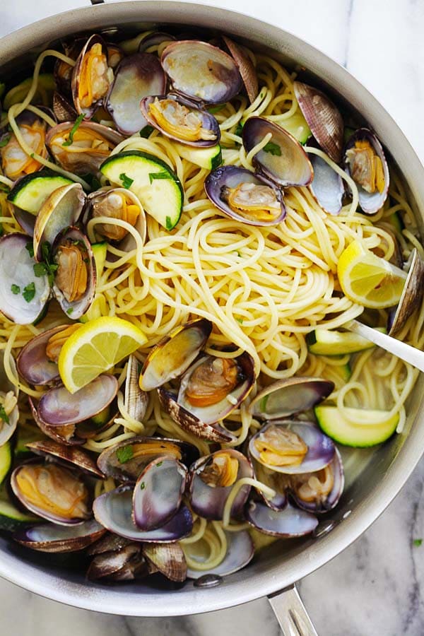 Close up of spaghetti pasta with clams, zucchinis in white wine sauce ready to serve.