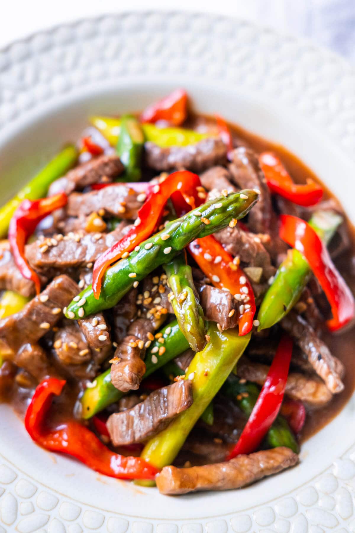 Easy Chinese beef asparagus stir fry with brown sauce that includes oyster sauce.