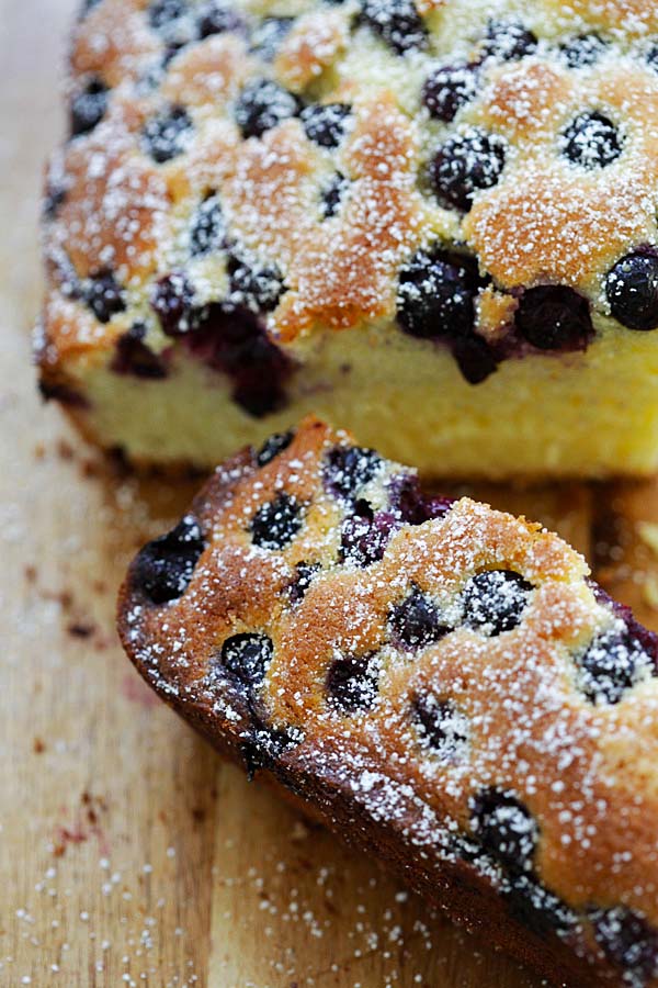 Sliced blueberry butter cake dusted with powdered sugar.