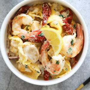 Garlic shrimp tortellini served on a plate.