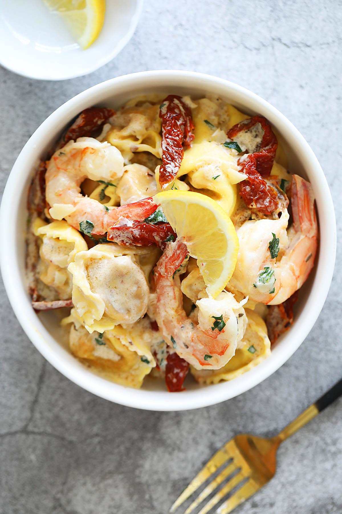 Garlic shrimp tortellini served on a plate.