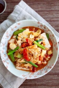 Tomato egg and tofu served on a plate.