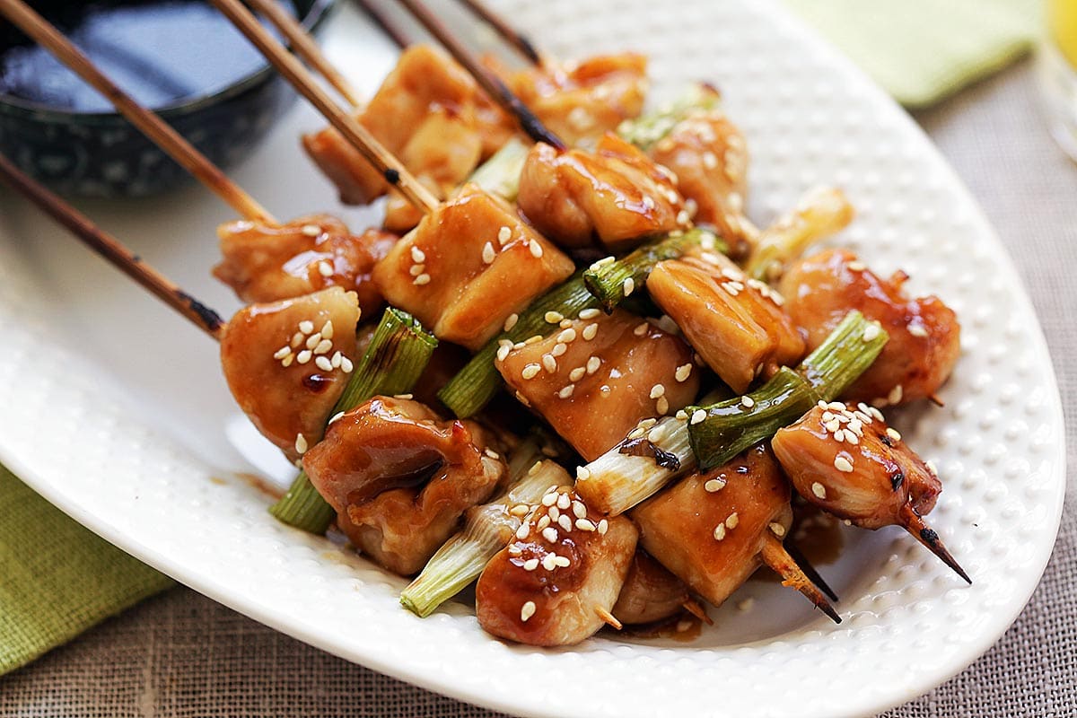 Japanese yakitori chicken skewers topped with sesame seeds. 