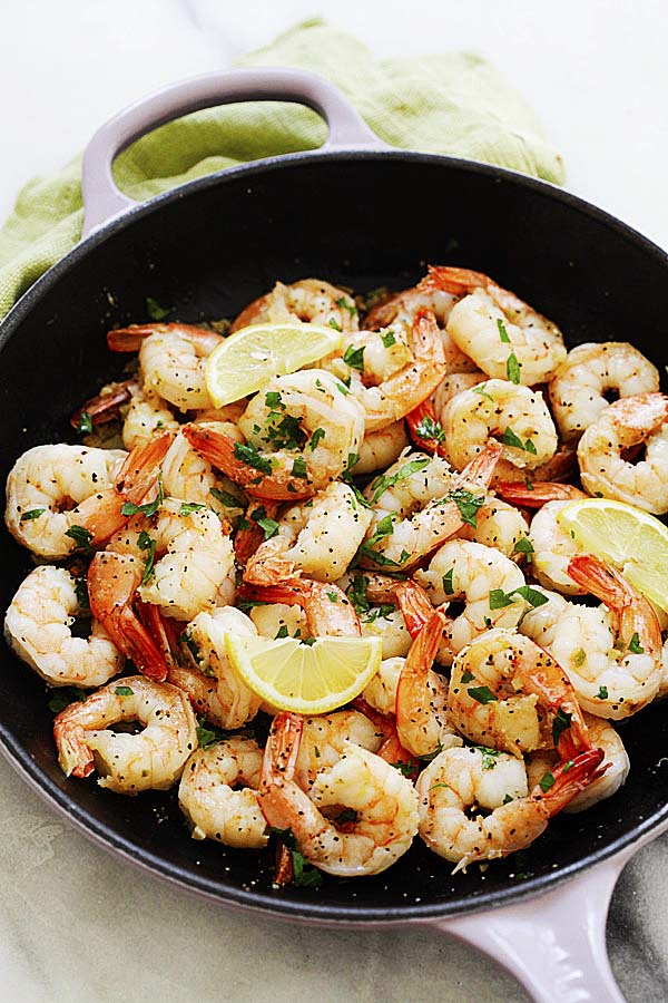 Easy and quick sauteed lemon pepper shrimp in a skillet.