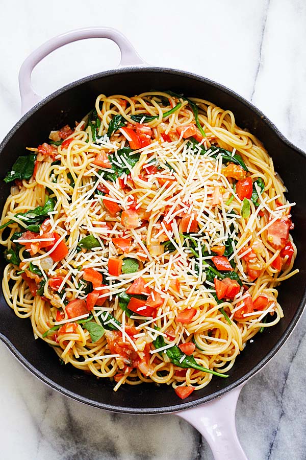 One-Pot Pasta in a pot, topped with shredded Parmesan cheese.