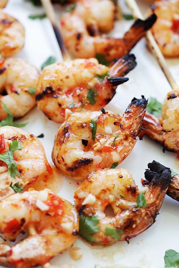 Grilled Thai shrimp skewers on bamboo sticks.