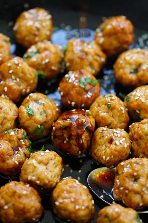 Teriyaki chicken meatballs marinade with Japanese teriyaki sauce in a skillet.