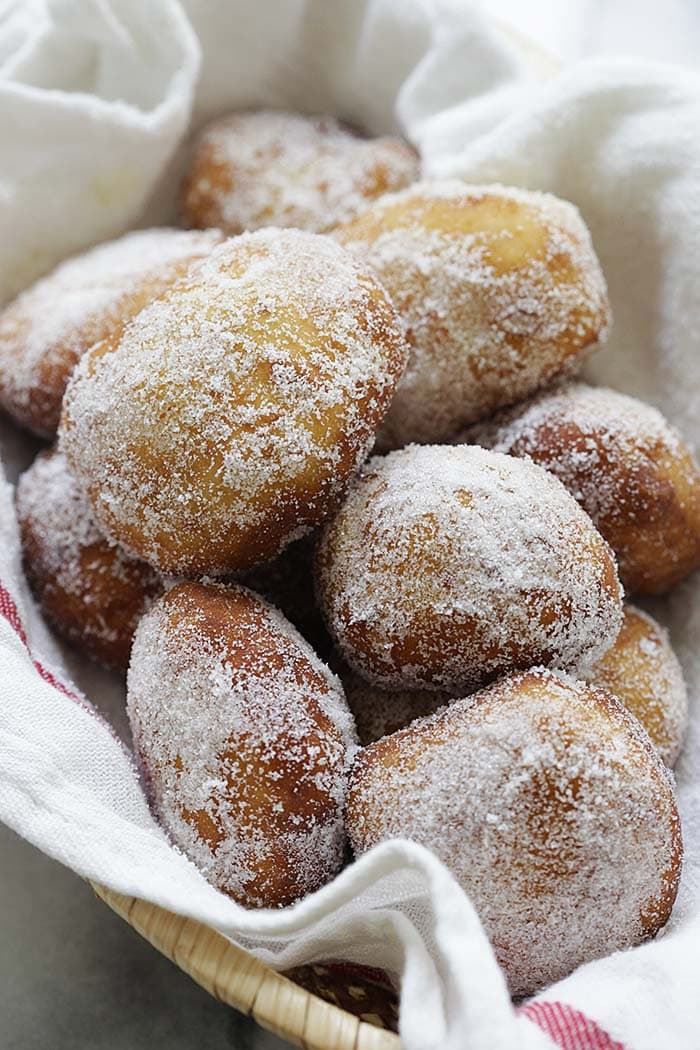 Easy and quick malasadas Portuguese donuts coated with granulated sugar.