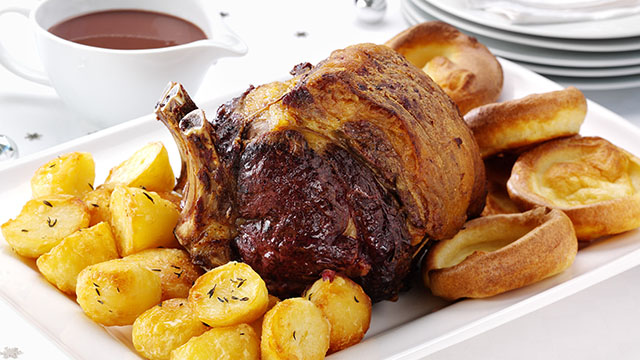 Yorkshire puddings with roast beef and potatoes. 