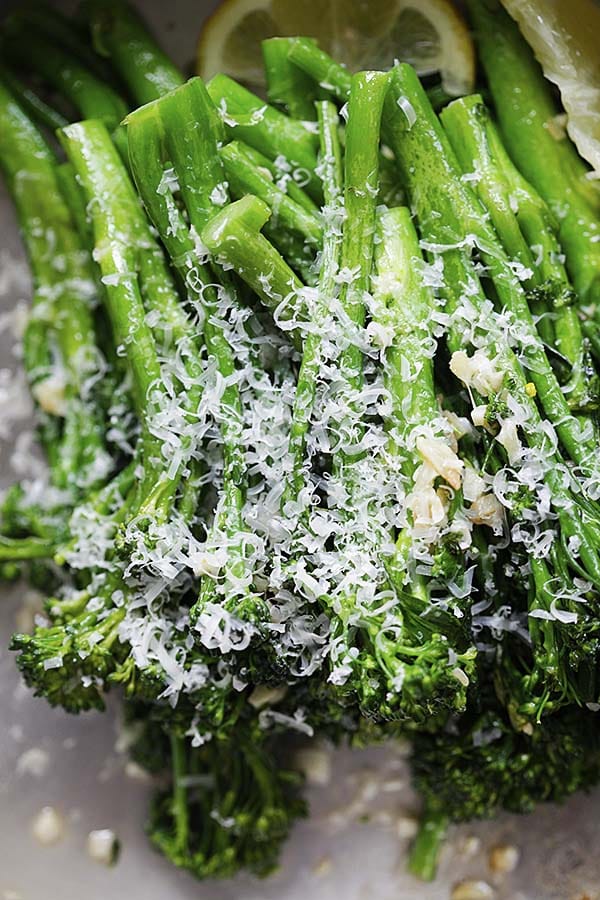 Shaving Parmesan cheese on top of broccoli, ready to serve.