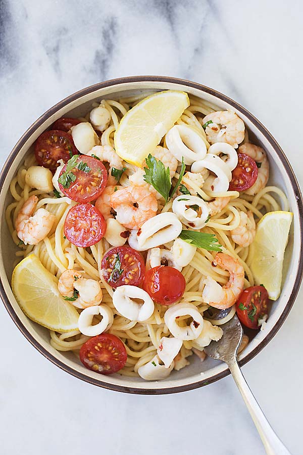 Seafood scampi spaghetti pasta with shrimp, squid and scallops, in a lemon butter sauce.