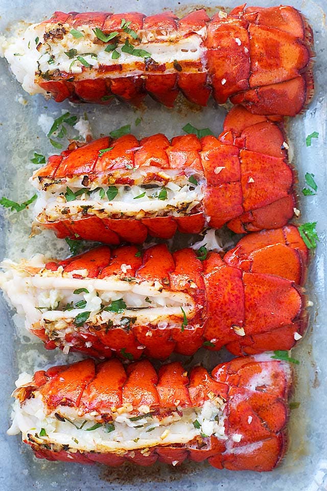 Garlic-butter is one of the best marinade for lobster recipes. Broiled lobster tails with lobster butter on a plate.