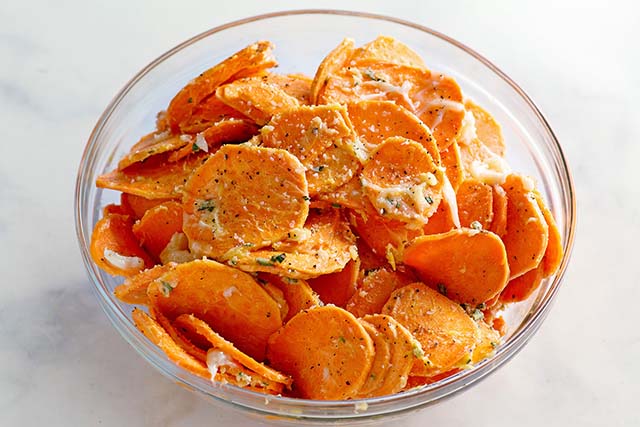 Sliced sweet potatoes coated with butter.