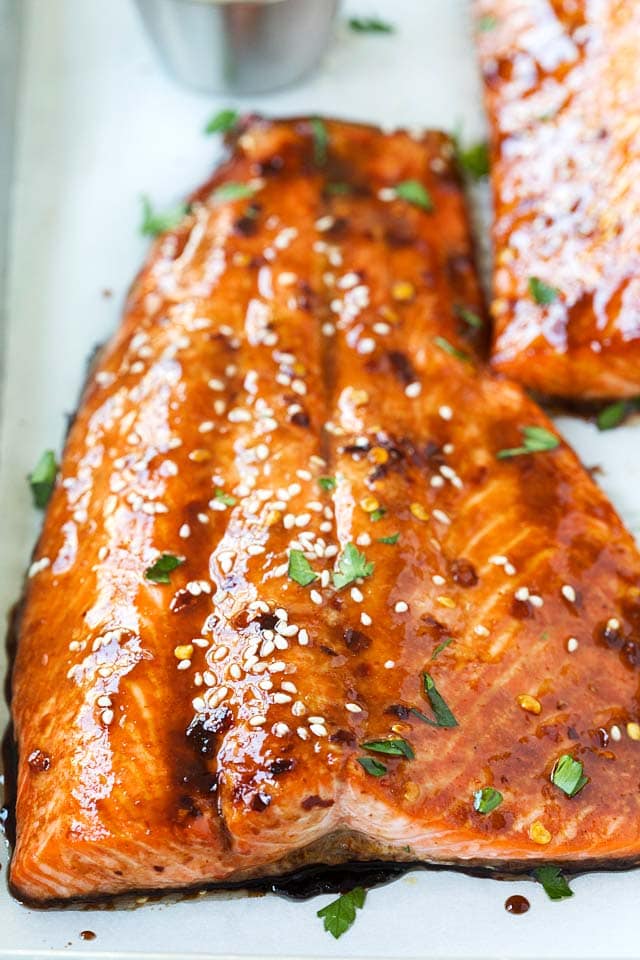 Close up of healthy homemade baked salmon with a sticky and dark soy sauce glaze.