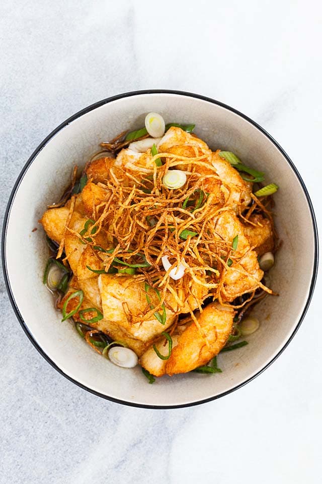 Halibut fish with ginger soy sauce in a bowl, ready to be served.