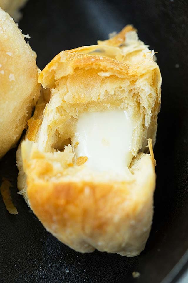 Close up picture of flaky melted cheese bombs.