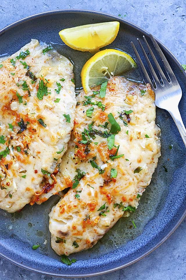 Baked tilapia topped with parmesan cheese and parsley.