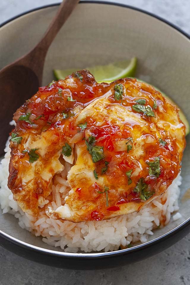 Egg meals with fried eggs and sweet chili sauce in a bowl.